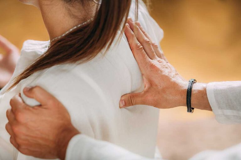 A patient consulting with a chiropractor about a back pain treatment plan in a comfortable clinical setting.